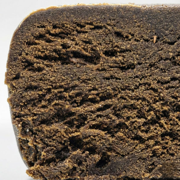 Photo macro du hashish CBD King Hassan GR33NZ, 25 % de CBD. Résine bio artisanale inspirée du Maroc, texture riche et arômes poivrés et naturels.